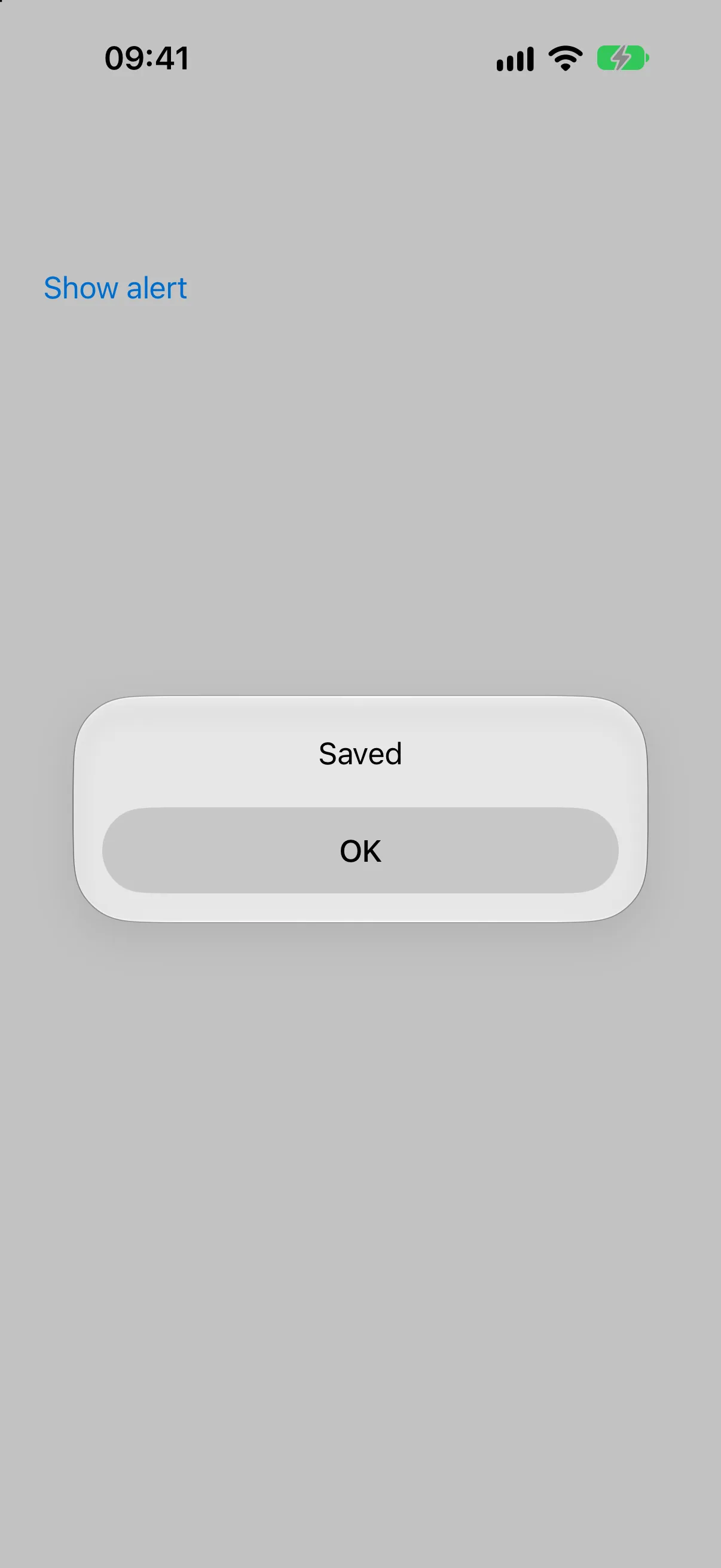 Alert titled Saved with a single OK button, above the Show alert trigger